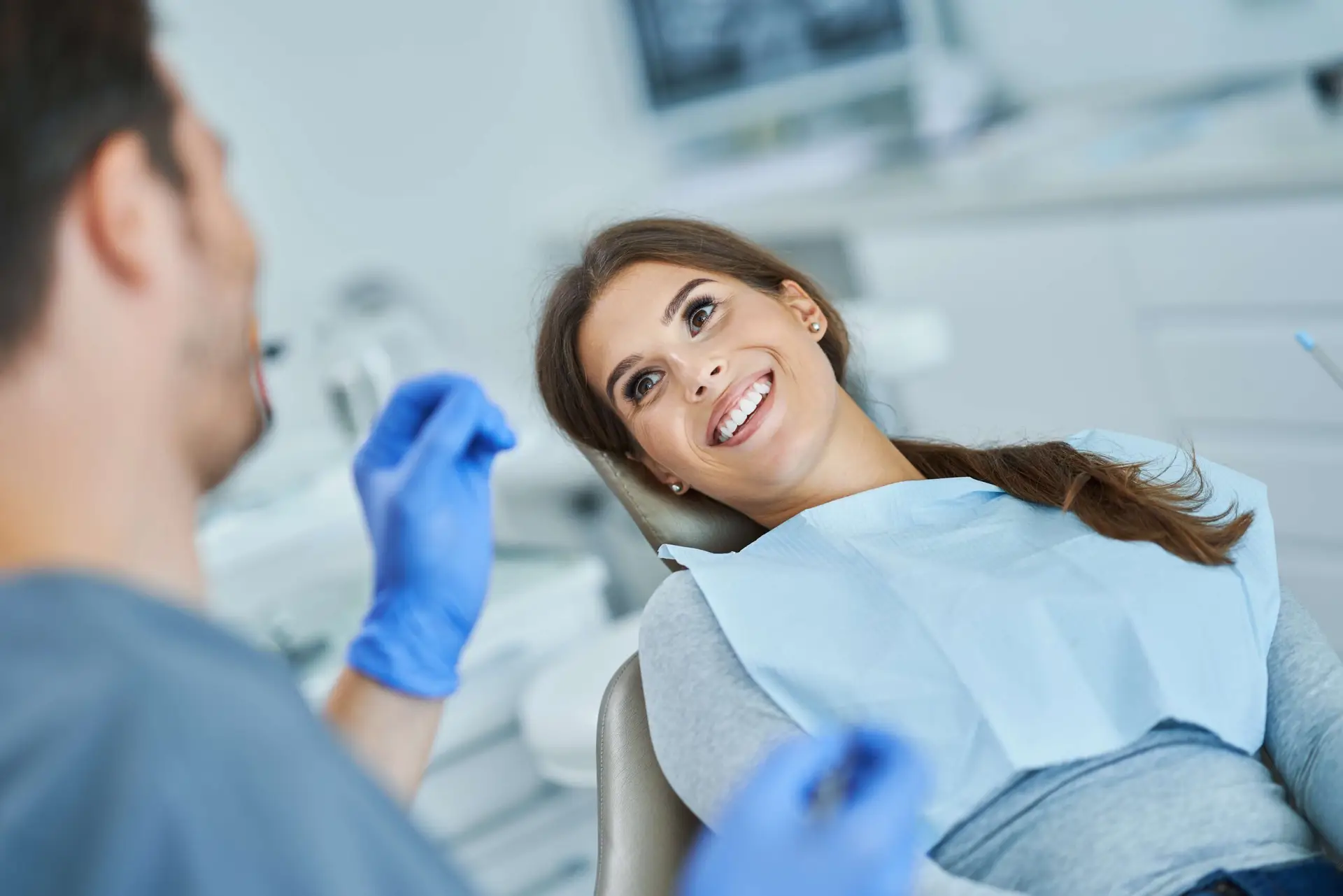 male-dentist-and-woman-in-dentist-office